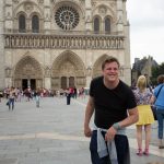 Man in front of Notre Dame Cathedral pretending to be the Hunchback