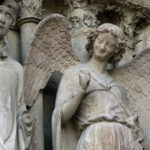 smiling angel on the Reims Cathedral; day trip to reims from paris