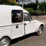 White 2CV car driving along in France: Driving in France episode