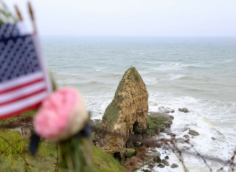 Pointe du Hoc with American flag in the foreground: D-Day History