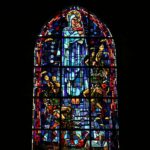 Stained-glass window at the Sainte Mère Eglise church picturing paratroopers landing on the village