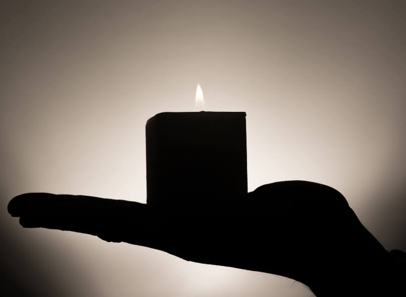 open hand with lit candle on top of it: stay safe in france episode