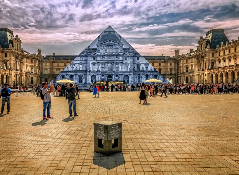 stylised photo of the louvre where the pyramid is see-trough and you can see the building behind it