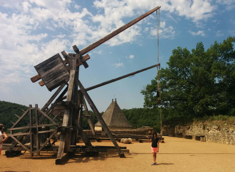 Matt's daughter in front of a large medieval lifting machine: Provence and Chamonix episode.