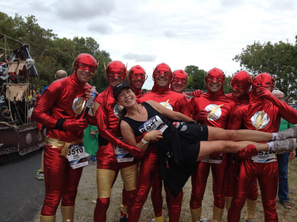 Janice at the Marathon du Médoc race, the Flash Gordon running team holds her horizontally