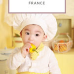 baby sitting on a table with a chef hat: table manners in france episode