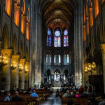 The inside of Notre Dame Cathedral with a wheelchair user in the center isle