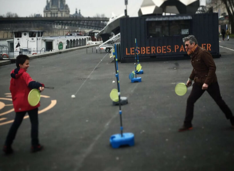 boy and dad playing on the banks of the Seine: two dads and a child in Paris episode