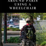 person in a motorized wheelchair riding along a sidewalk