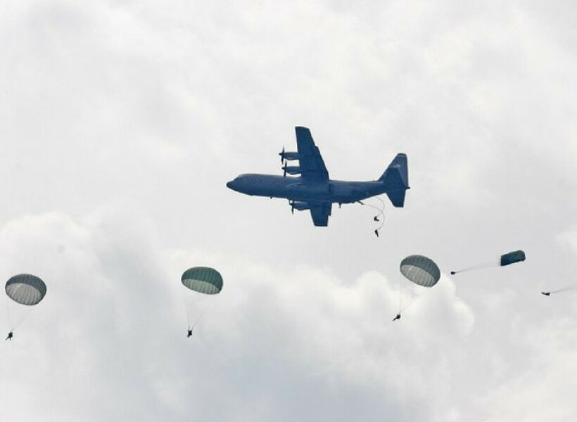 Paratroopers re-enacting the events of D-Day by jumping out over Normandy from a vintage airplane: Normandy WW2 episode