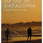 man and woman walking along a sandy beach in catalonia