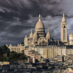 A view of Montmartre and the Sacré Coeur Basilica under a stormy sky