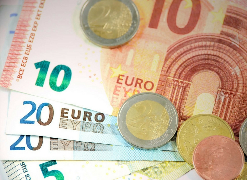 Euro coins and bills; paris on a budget