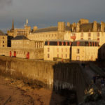 city of Saint-Malo at dusk showing the rampart walls mentioned in the book all the light we cannot see