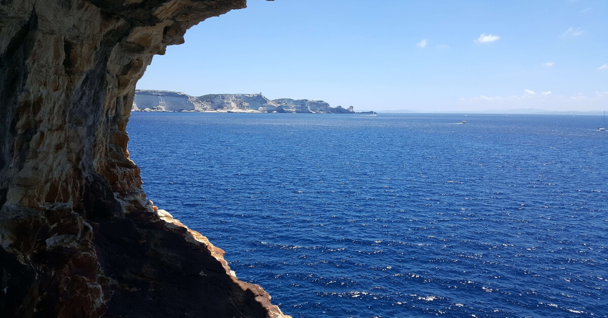 rocky cave with view on the blue mediterranean in corsica