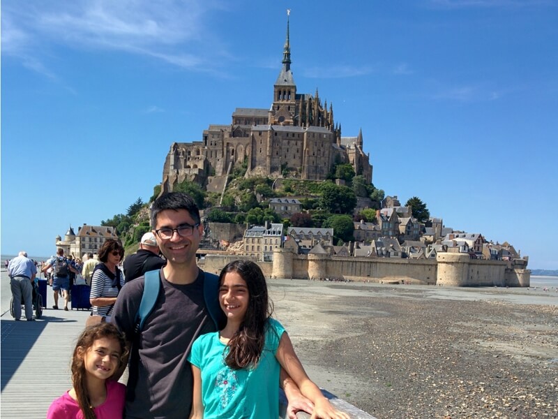 Matt and his daughters in front of the Mont-Saint-Michel; Brittany with Kids