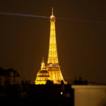 the eiffel tower at night seen from paris rooftops; things to do in paris