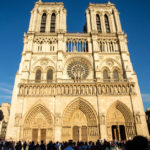 Notre Dame Cathedral seen in the evening light against a blue sky background