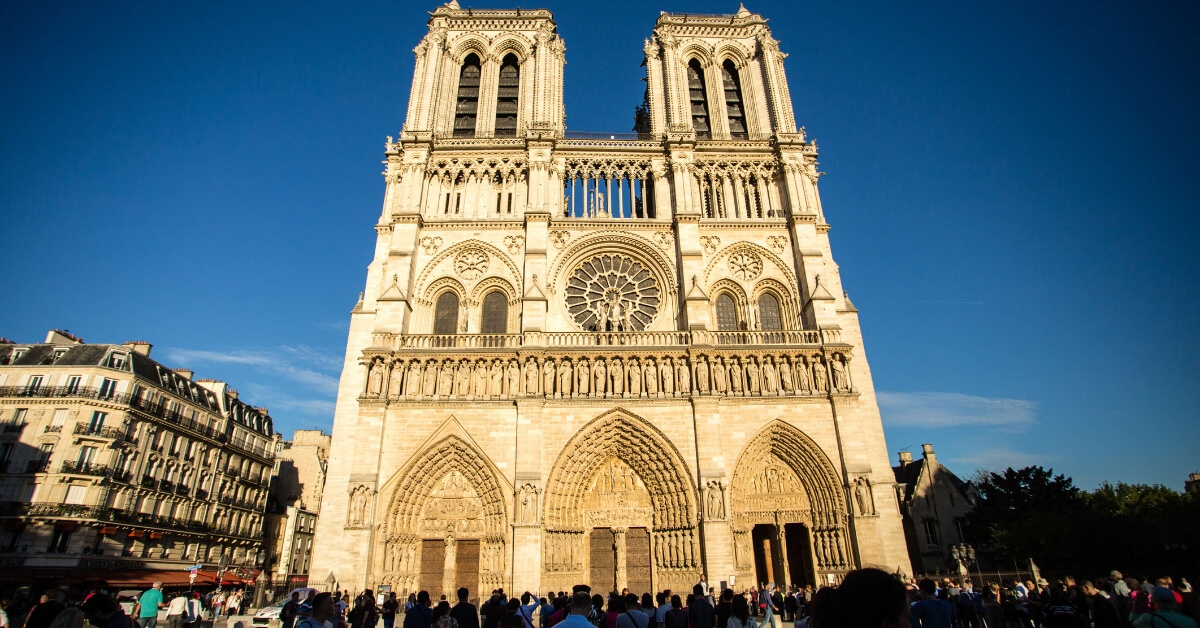 Notre Dame Cathedral seen in the evening light against a blue sky background