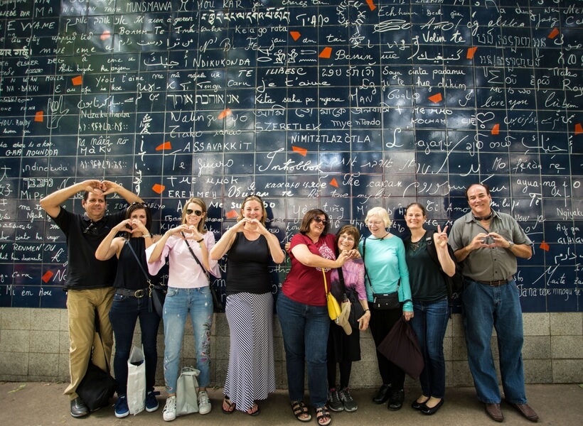 the lure of montmartre examined, episode 134, Addicted to France tour members in front of the wall of love