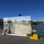 Visiting Paris in August Episode: man painting a Paris landscape on the Pont des Arts on a sunny day in Paris