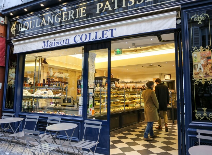 boulangerie in paris, a man and a woman waiting in line in front of the counter