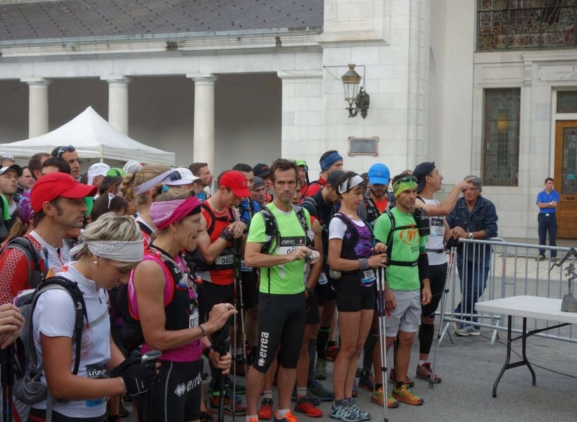 Marion Clignet waiting for the start of a race with trekking poles, group of runners