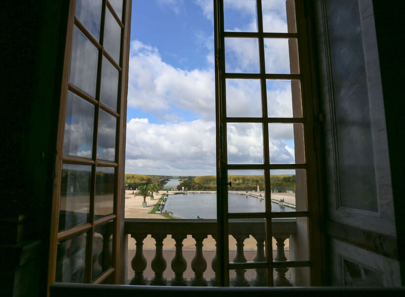 a view on the Versailles gardens from the Château, open window. Day trip to versailles from paris