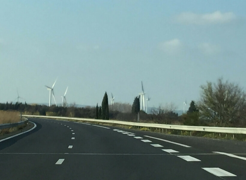 wind turbines along a road in france; sign that indicates that a speed radar is coming up