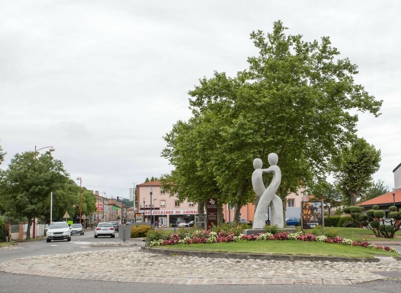 roundabout decorated with a sculpture; is renting a car in france worth the trouble