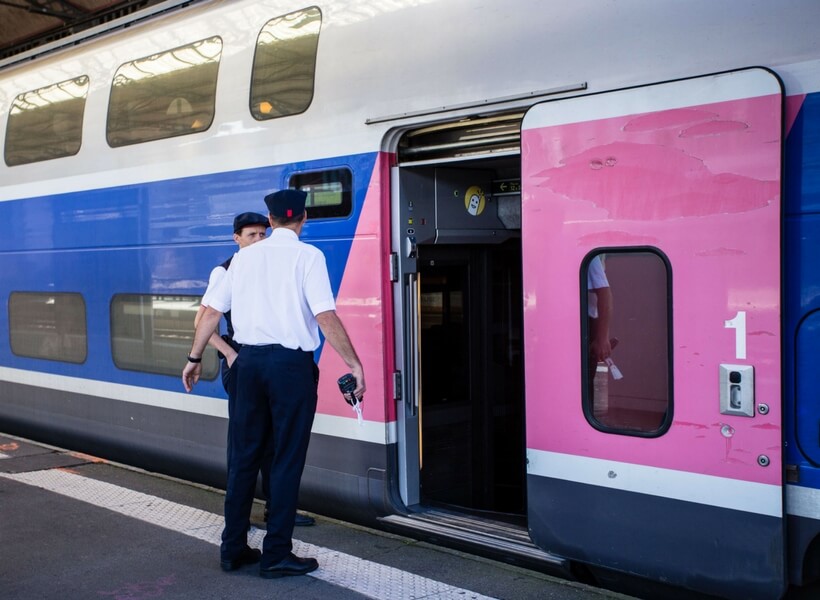 train employees in front of a train in france; train strikes in france