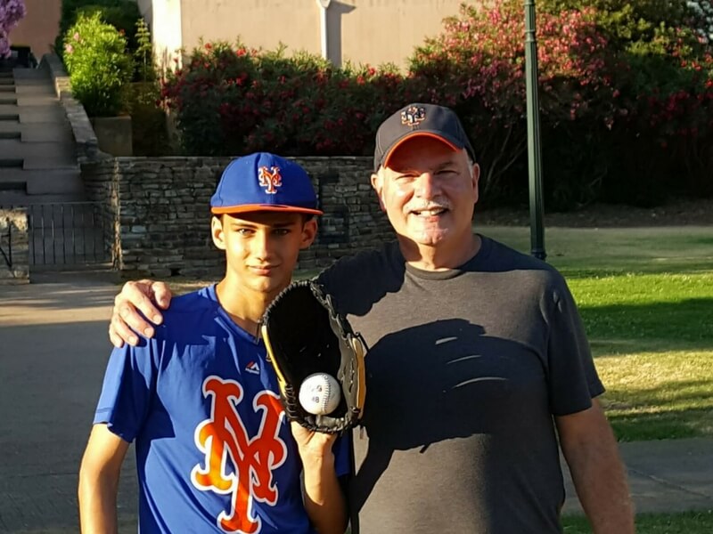 william and his young protege in corsica: the boy is wearing his baseball attire with glove and ball