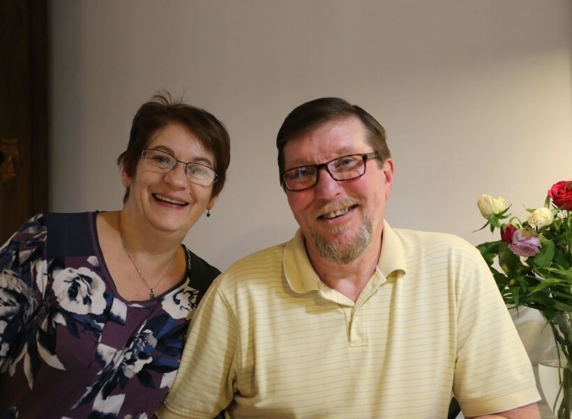 Man and woman looking at the camera with smiling faces