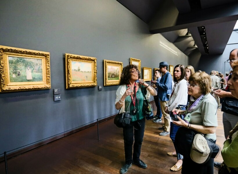 Elyse guiding a group inside of the Orsay Museum