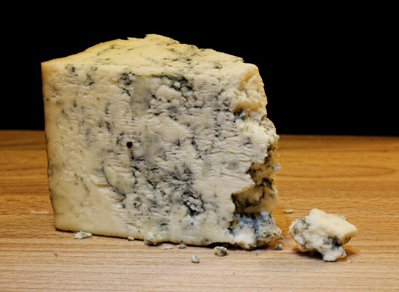 Roquefort cheese on a wooden platter