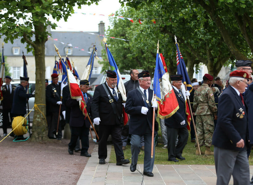 Officials at a commemoration ceremony at Sainte-Mère-Église