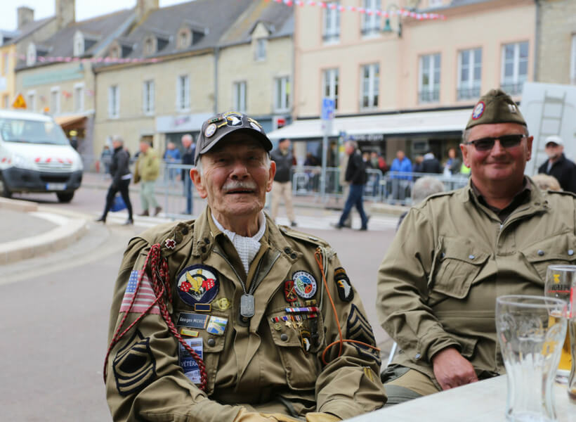 Veteran visiting Normandy to celebrate D-Day 2018 sitting at a café in Sainte-Mère-Église