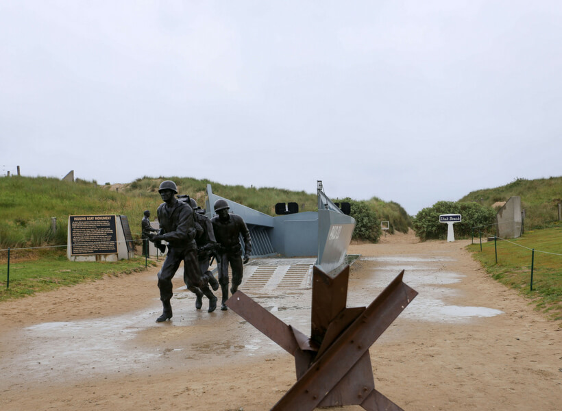 Statues of soldiers coming out of a landing craft