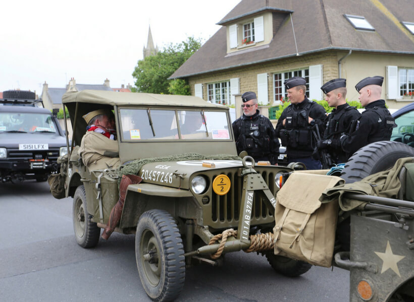 Operation Overlord reemactors chat with French police in Arromanches-sur-Mer