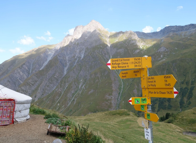 signs along the tour du mont blanc that indicate how long it will take to get to various destinations