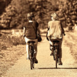 two retired women riding their bicycles in the French countryside