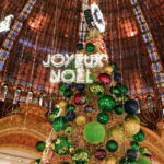 2018 Christmas tree at the Galeries Lafayette Haussmann and sign that says Joyeux Noel