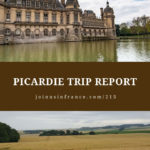 Chateau of Chantilly surrounded by water with a dramatic blue sky and white clouds and wheat field in rural Picardie