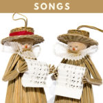 Christmas ornaments made of straw holding sheet music and singing French Christmas Songs