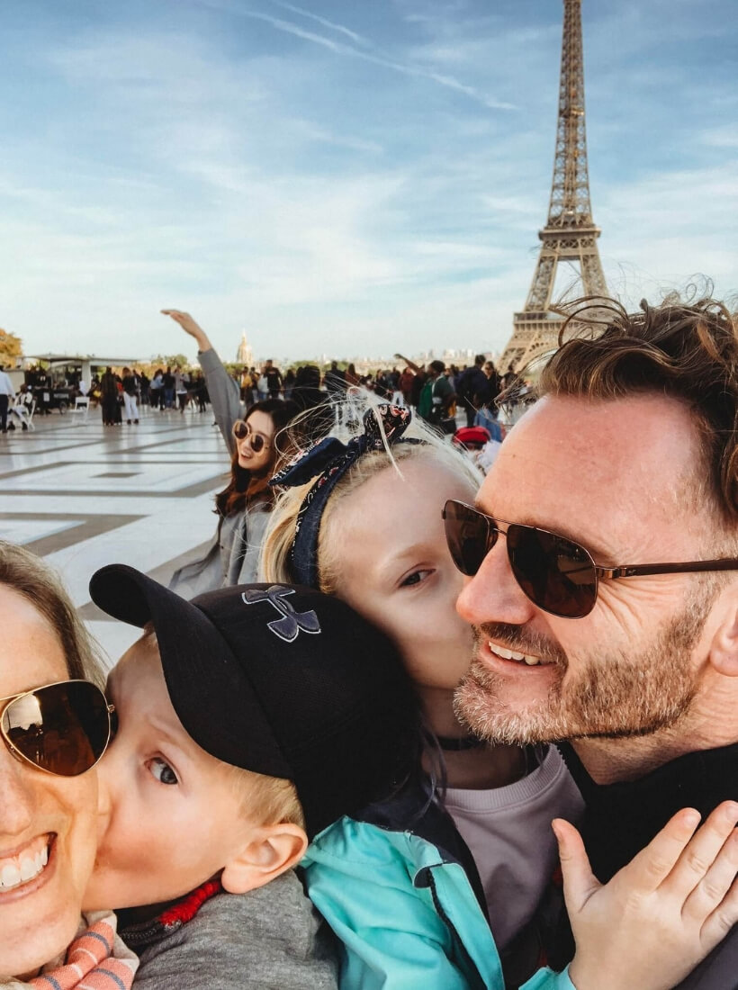 Jessica, her husband, son and daughter looking very happy and posing on the Trocadero in front of the Eiffel Tower: Great Activities in France for Families with Children episode