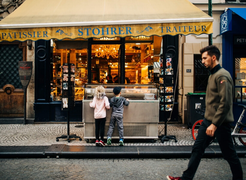 boy and girl carefully examining the ice cream flavors at their disposal on a Paris street: vacation photos