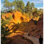 boy walking down a boardwalk while visiting red-rock country in Roussillon: Great Activities in France for Families Episode