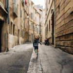 boy skipping happily in the middle of a French medieval street: vacation photos episode