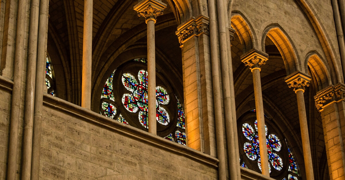 Stained-glass windows and stone columns inside Notre Dame before the fire of April 15, 2019