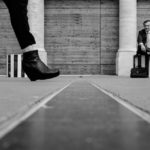 person with interesting shoes and man in the background: paris street photography episode